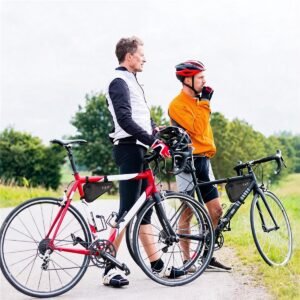 Two Male Cyclists Resting on a Rural Road with Red and Black Road Bikes, Each Bike Fitted with a Black Triangle Frame Bag, Helmets, Green Countryside - Fmosbag - Oem Bag Manufacturer & Custom Bag Factory