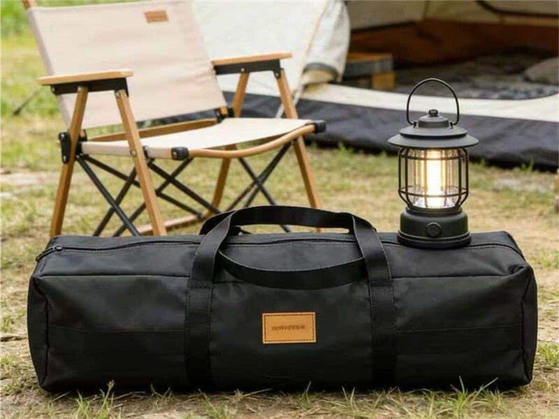 Camping Gear Storage Bag — Durable Outdoor Equipment Duffel Bag - Fmosbag - Oem Bag Manufacturer & Custom Bag Factory - Fmosbag - Oem Bag Manufacturer & Custom Bag Factory Black Camping Gear Storage Bag with Reinforced Handles Next to Camping Chair and Lantern at Tent Site - Fmosbag - Oem Bag Manufacturer & Custom Bag Factory - Fmosbag - Oem Bag Manufacturer & Custom Bag Factory