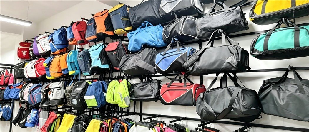 Wall of Colorful Custom Sports and Gym Bag Samples in the Fmosbag Showroom - Fmosbag - Oem Bag Manufacturer & Custom Bag Factory - Fmosbag - Oem Bag Manufacturer & Custom Bag Factory