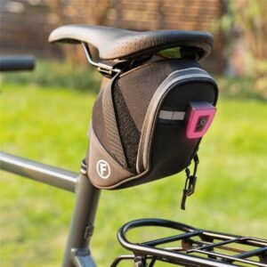 Outdoor Bike Seat Pack Installed on a Bike - Fmosbag - Oem Bag Manufacturer & Custom Bag Factory Outdoor Bike Seat Pack Installed Under Saddle on Bike with Rear Rack, Pink Usb Tail Light, White F Logo, Reflective Trim, Black Woven Straps, Green Grass Garden Background - Fmosbag - Oem Bag Manufacturer & Custom Bag Factory