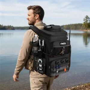 55l Fishing Backpack Worn by Male Angler Walking Along a Lake Shore, Black 900d Oxford, Side Water Bottle, Molle Webbing, D-rings, Plier Holders, Fmos Label, Forest Background - Fmosbag - Oem Bag Manufacturer & Custom Bag Factory