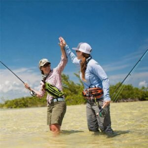 Unisex Fly Fishing Waist Pack Worn by Two Anglers Wading in Clear Shallows Under Blue Sky - Fmosbag - Oem Bag Manufacturer & Custom Bag Factory Two Women Anglers High-fiving in Shallow Saltwater Flats, Each Wearing a Fly Fishing Waist Pack and Holding Fly Rodsimage Title: Fly Fishing Waist Pack on the Flats - Fmosbag - Oem Bag Manufacturer & Custom Bag Factory