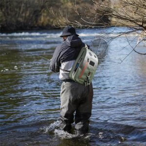 Two Fly Fishing Sling Packs Worn by an Angler Wading in a River, Casting a Rod with Landing Net Attached, Winter Stream Background - Fmosbag - Oem Bag Manufacturer & Custom Bag Factory